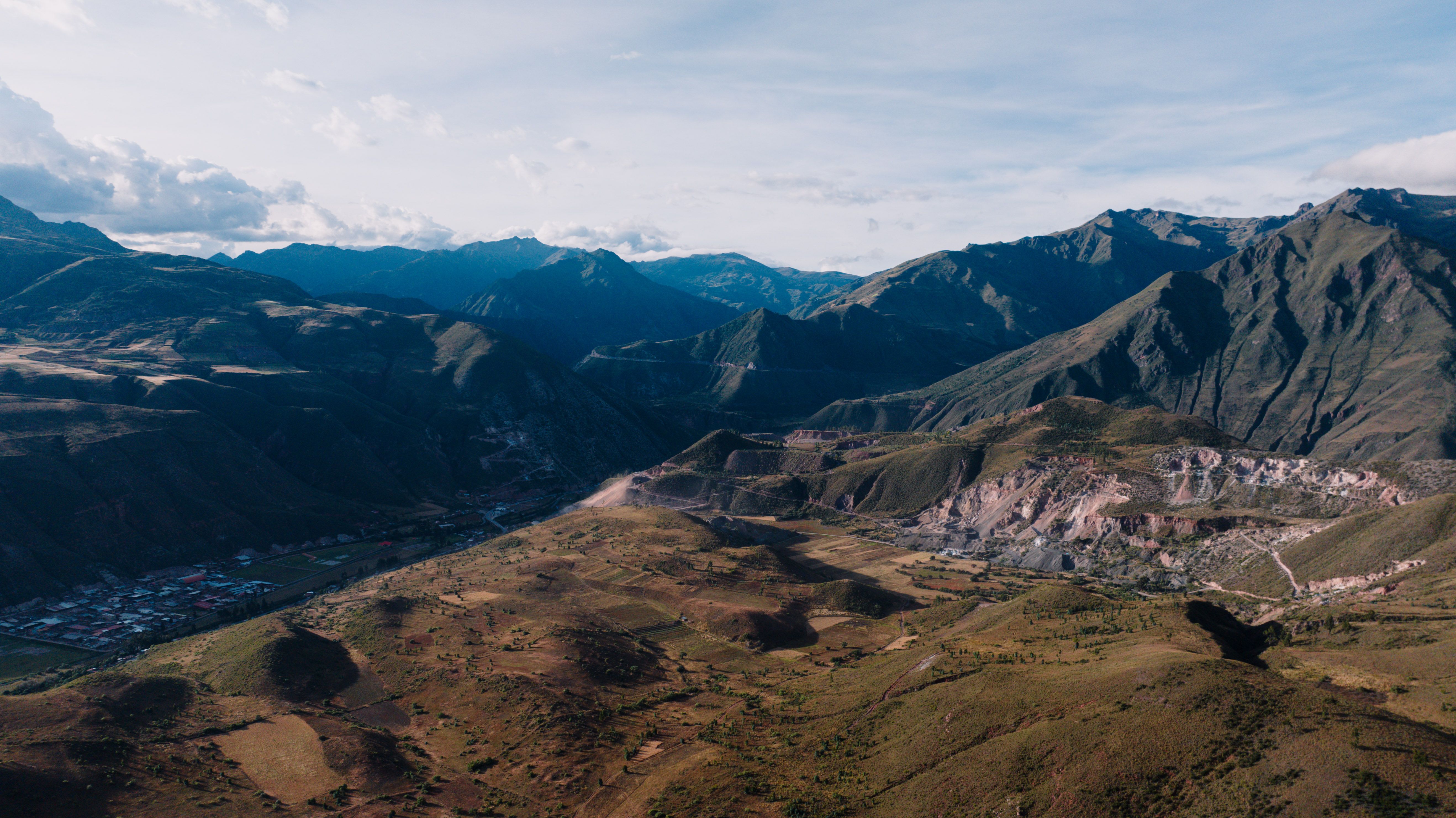 Stunning aerial view of mountainous landscape near Cusco, Peru showcasing vast valleys and villages.