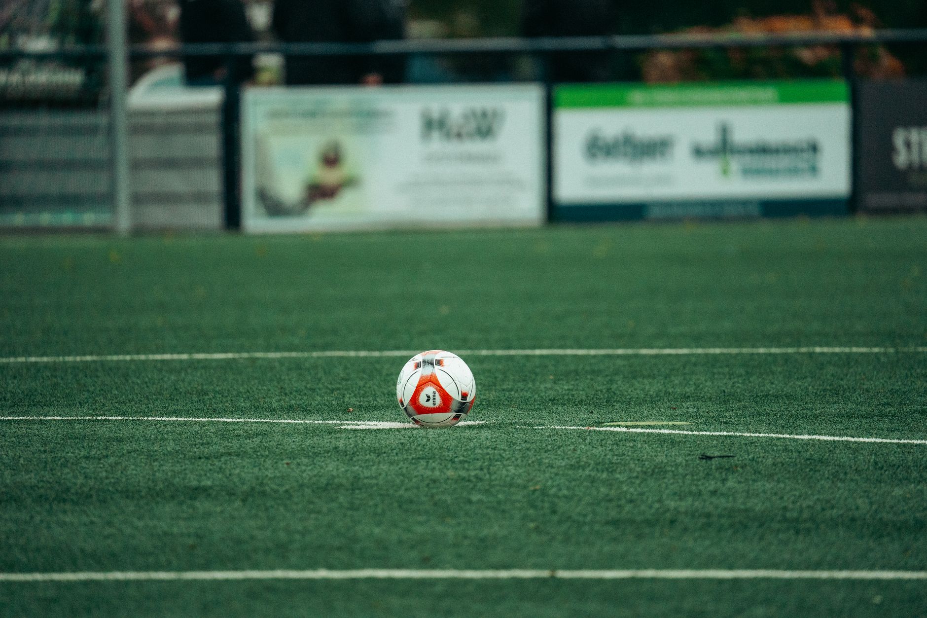 A detailed shot of a soccer ball on a lush green field, perfect for sports-related themes.