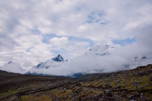 Breathtaking view of clouds enveloping the Andes Mountains in Pajchanta, Qosqo, Peru.
