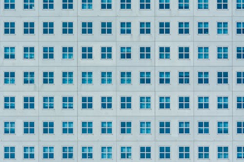 A blue wall with many windows