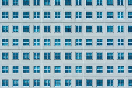 Free Symmetrical building facade with blue windows in Rotterdam, Netherlands. Stock Photo