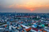 日落时分，从空中俯瞰城市景观，密集的房屋与充满活力的天空构成了一幅令人惊叹的画面