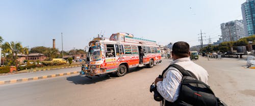 MAN WATCHING OLD BUS