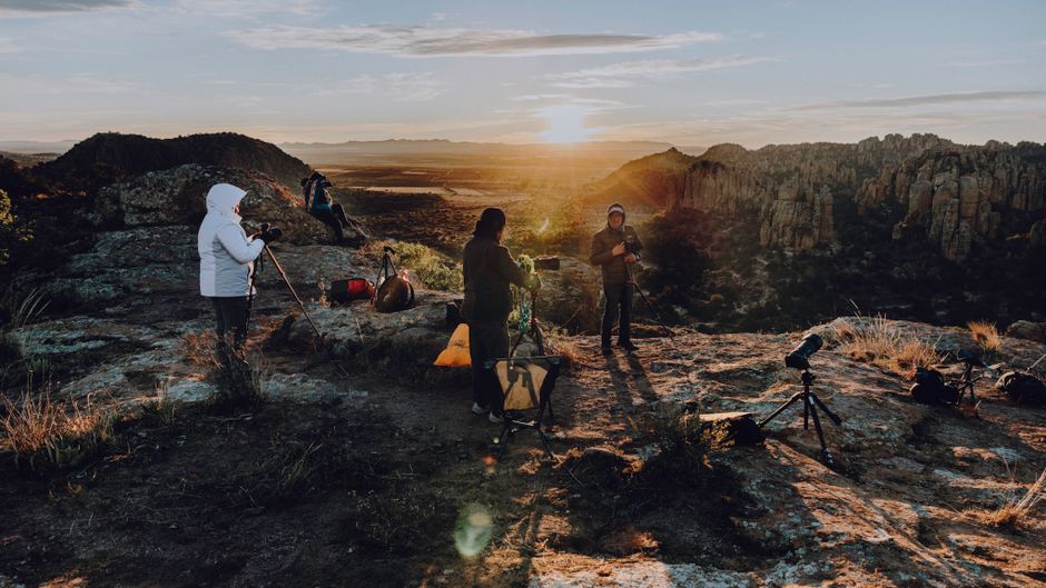 Stunning Expedition to the Arch and to the Lands End, with Snorkeling Beach. Review: Your Ultimate Cabo San Lucas Adventure Guide Review 2026 - Group of photographers with tripods capturing a stunning sunrise on a rocky cliff. Perfect for adventure and travel themes.