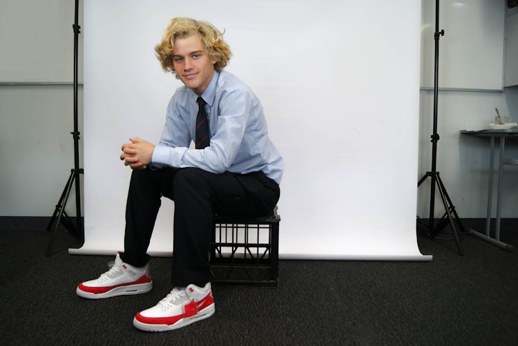 Man Sitting On Black Stool