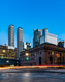 Explore the modern Toronto skyline with illuminated skyscrapers at dusk.