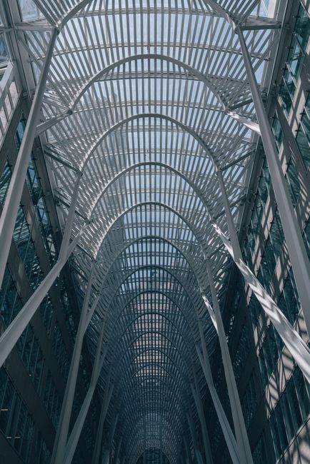 A stunning perspective of a modern architectural design showcasing steel arches and glass in Toronto, Ontario.