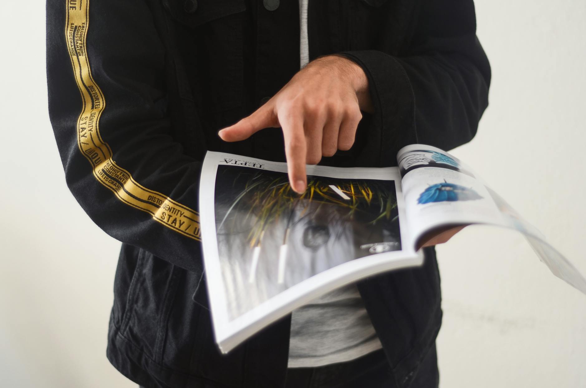 Unknown Person Pointing at Magazine