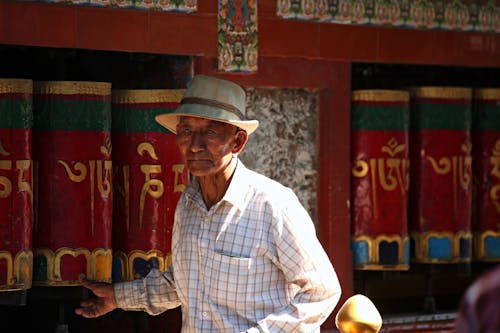 Man Standing Near Red Wooden Wall
