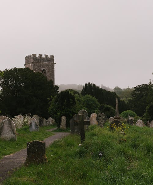 A graveyard with a tower in the background