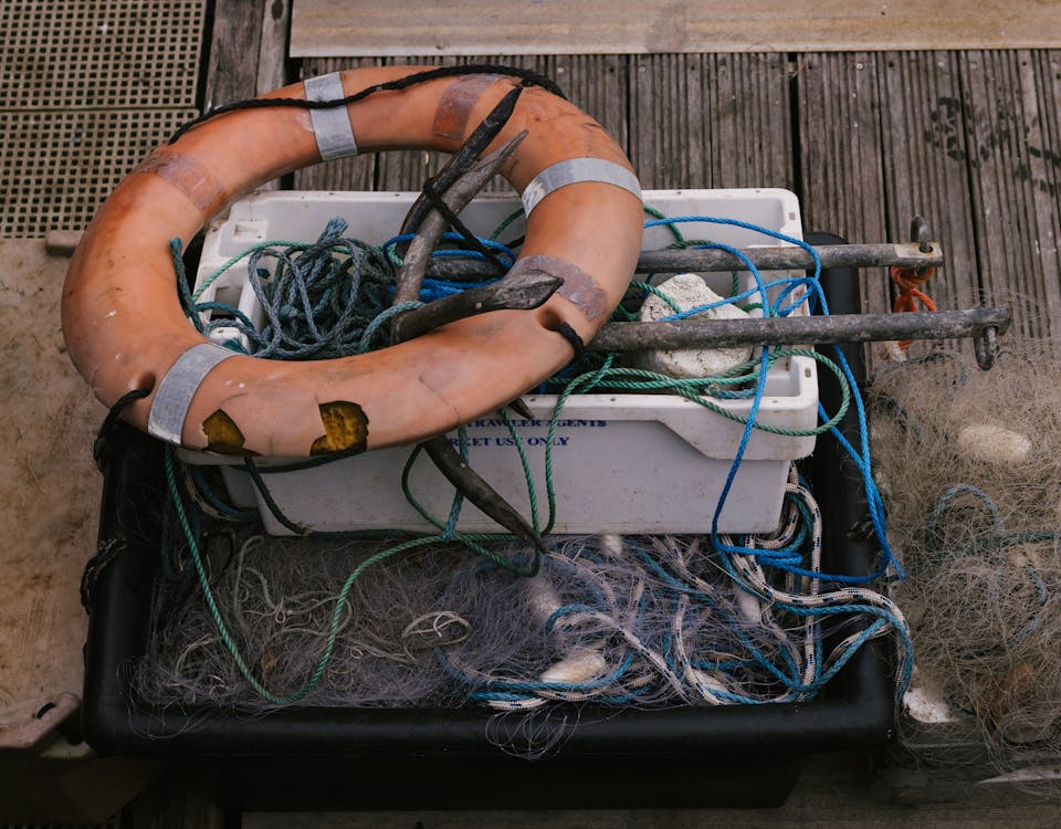 A life preserver and fishing net on a boat