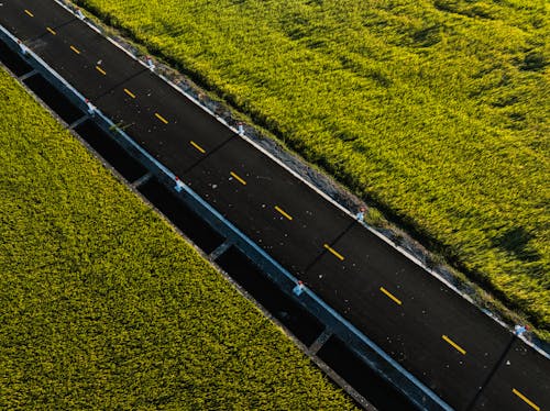 An aerial view of a highway with grass on both sides