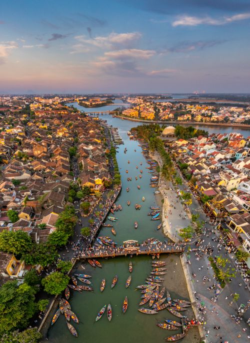 Free Bird's eye view of Hội An's scenic river, bridges, and vibrant cityscape. Stock Photo