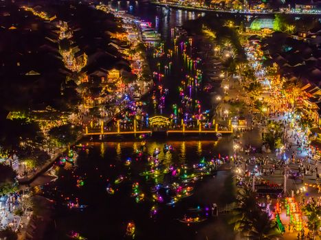 A vibrant aerial shot of Hội An's lantern festival, showcasing colorful lights and bustling waterfront.