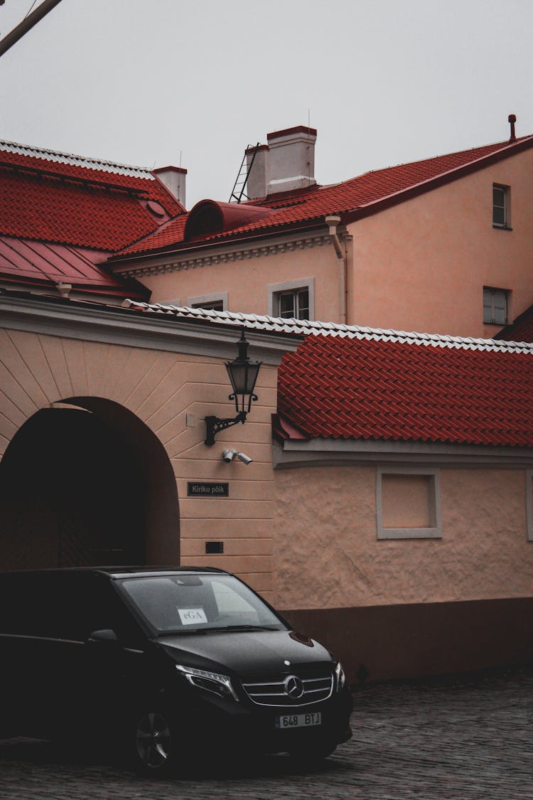 Black Mercedes Benz Van Near House