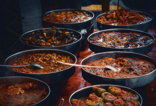 A large number of dishes of food on a table