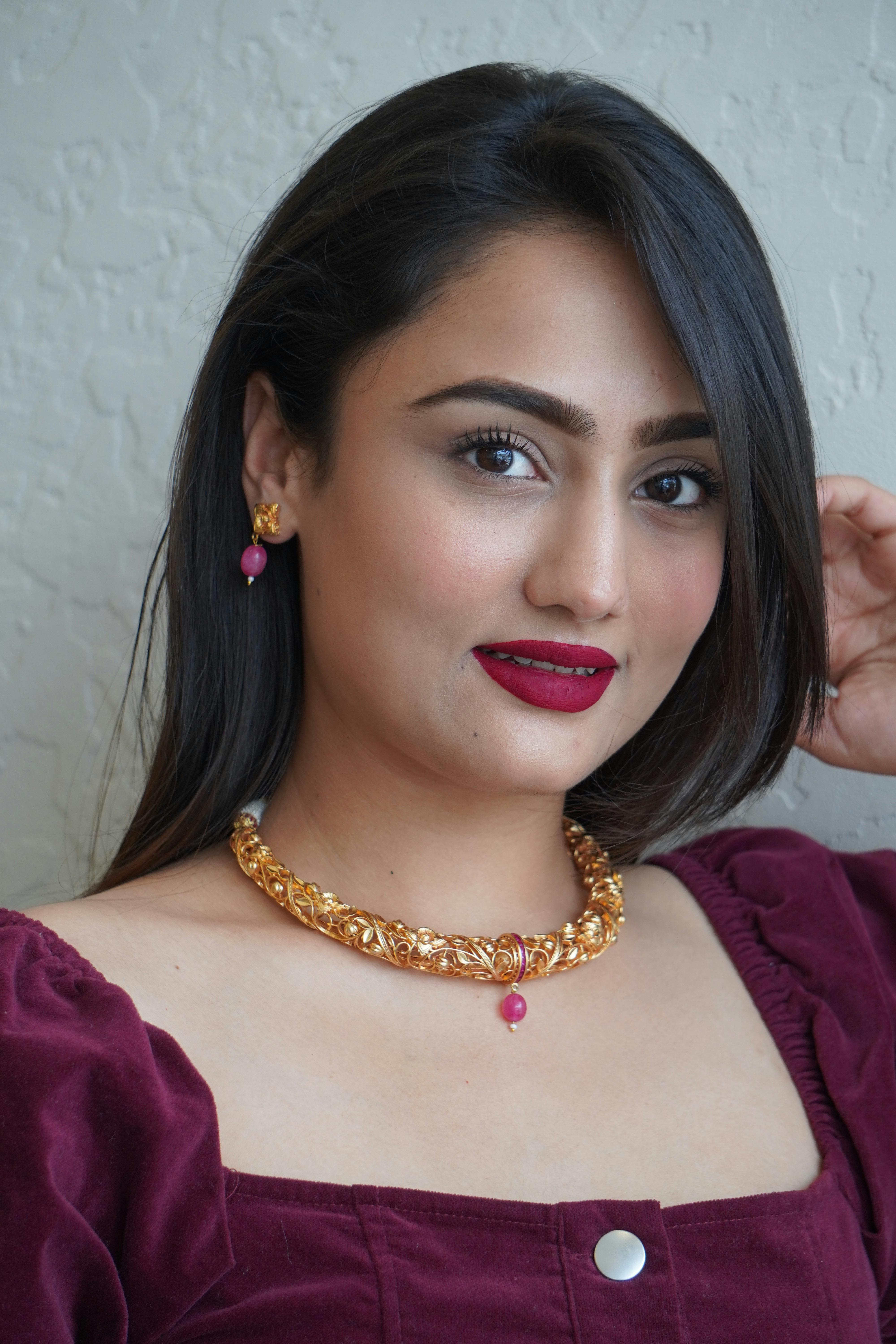 model in gold jewelry with pink stones