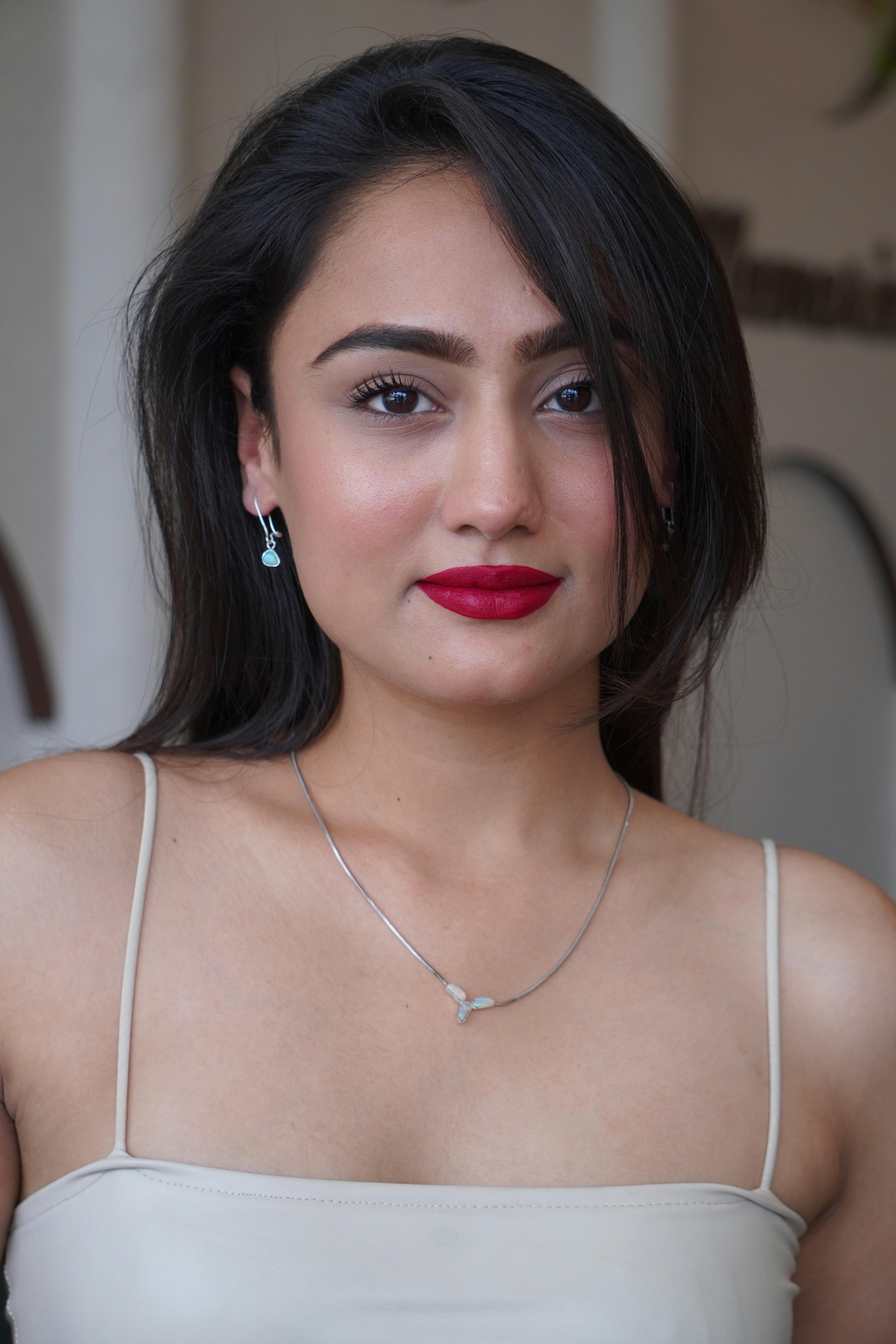 model wearing a necklace with blue crystals and earrings