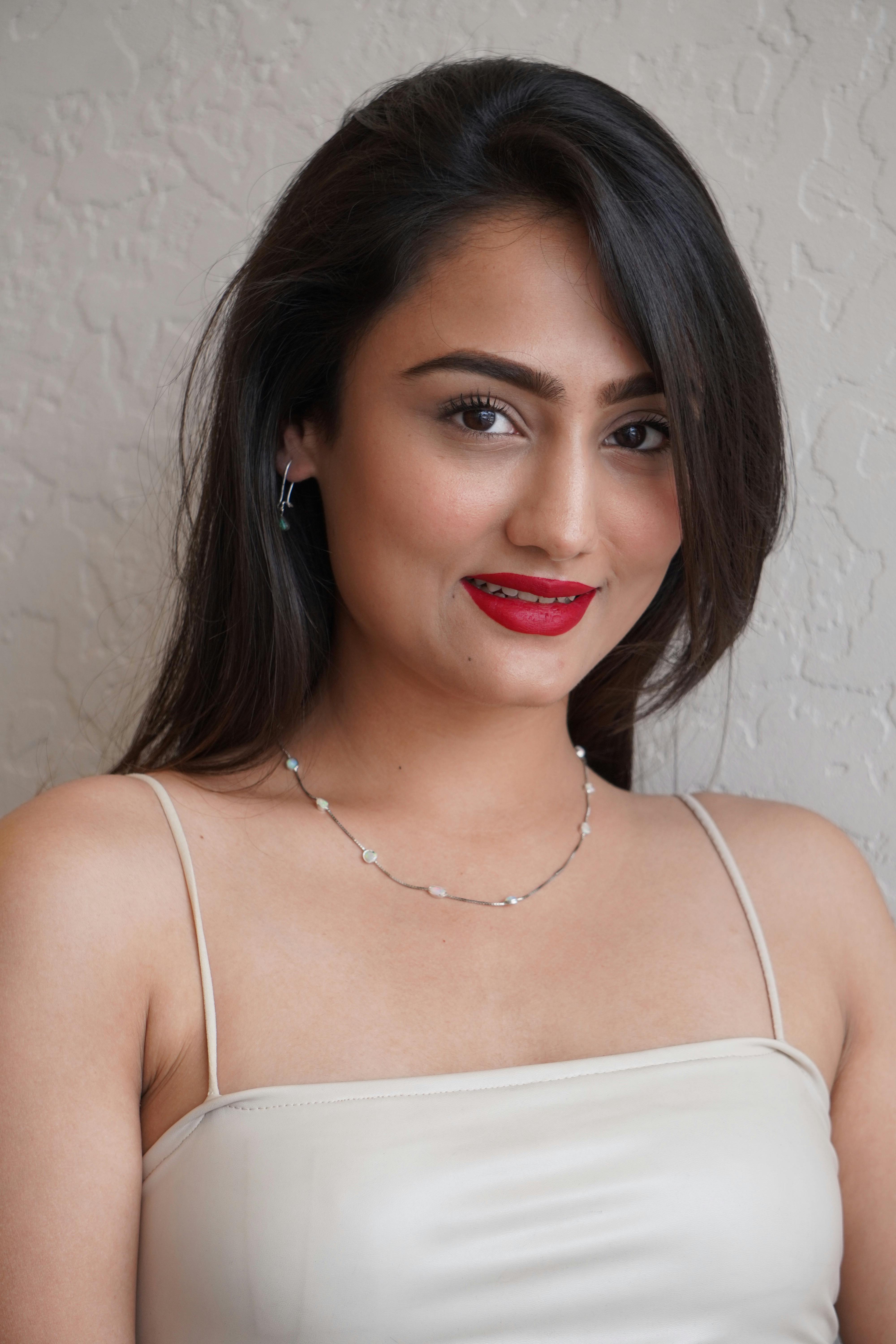 smiling model in white blouse and jewelry