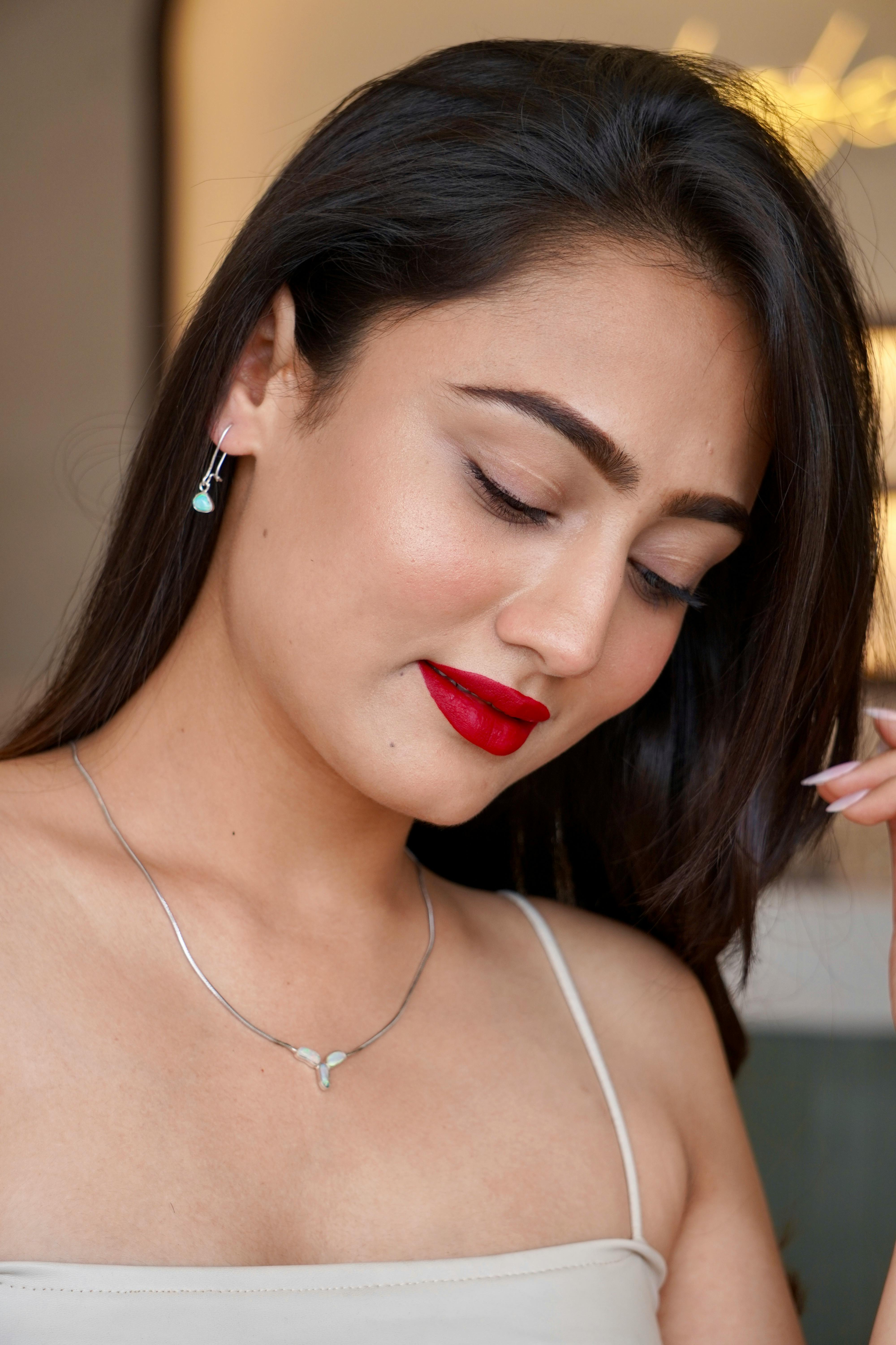 model wearing silver jewelry with blue crystals