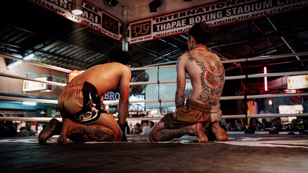 Free Man Kneeling on Boxing Ring Stock Photo