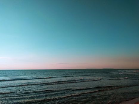 Calm ocean waves under a serene twilight sky, capturing the tranquility of nature.