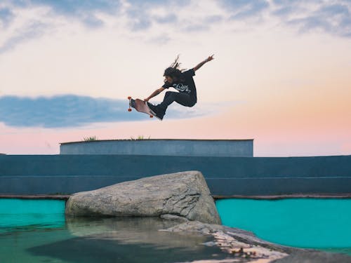 Free Man In Mid Air With Skateboard Stock Photo