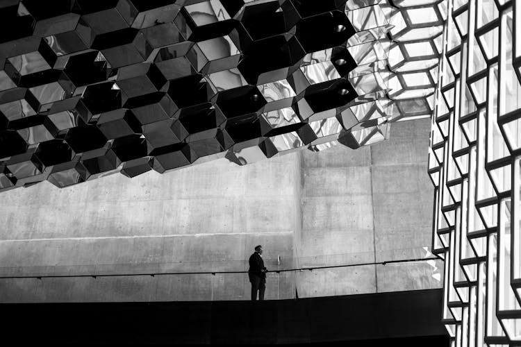 Man Standing Near Railing In Building