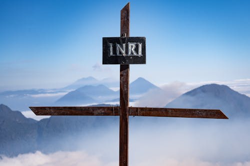 A sign pointing to the word inu with a mountain in the background