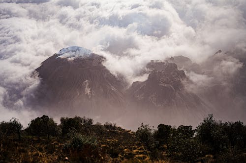 A mountain covered in clouds and fog