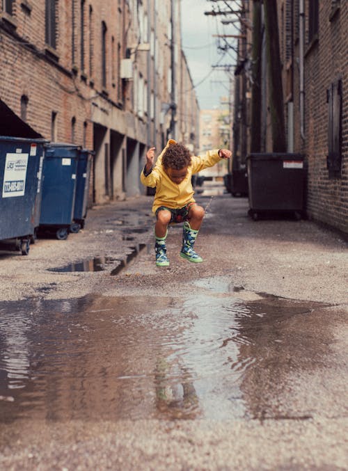 Free Child Jumping Into Body of Water Stock Photo