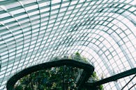 现代中庭采用玻璃和钢结构，展示着郁郁葱葱的绿色植物