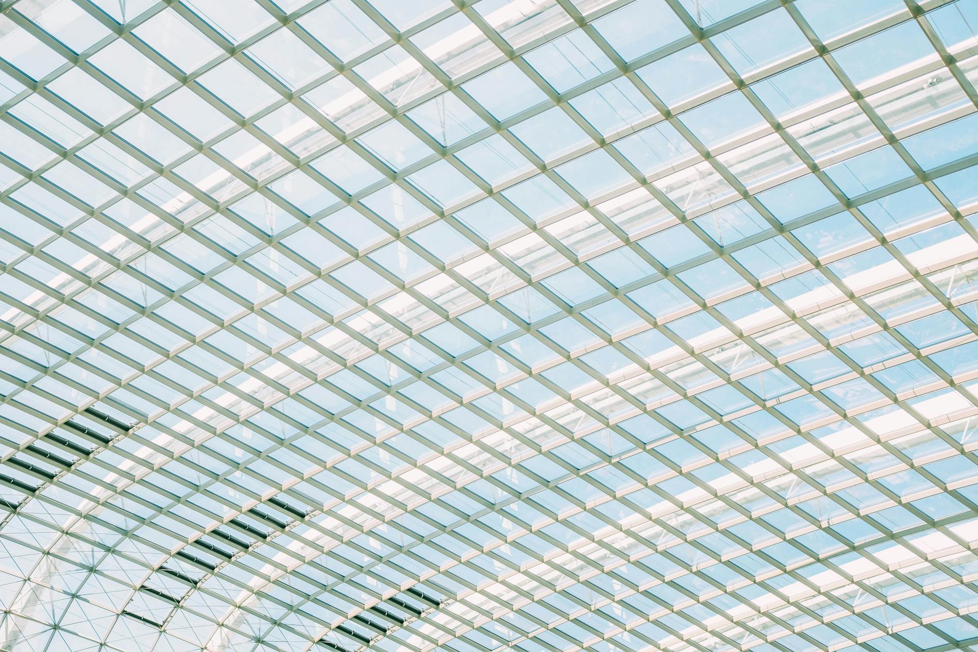 Futuristic glass ceiling showcasing geometric patterns and natural light.