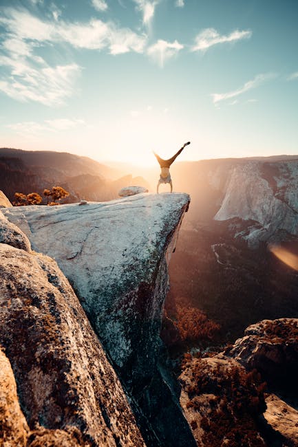 Thrilling handstand on a cliff edge in Yosemite National Park during sunset.