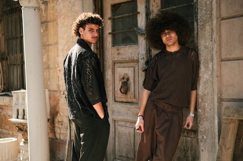 Two men standing in front of an old building