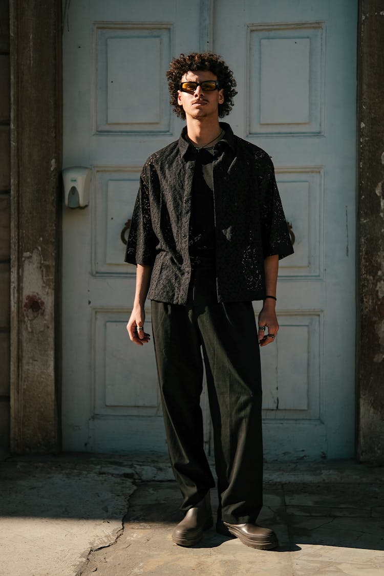 Man In Black Clothes Standing Near Door