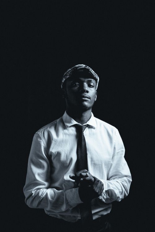 Free Elegant black and white portrait of a man in a beret and tie, exuding confidence and style. Stock Photo