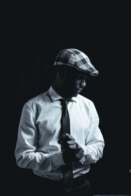 Free Striking black and white portrait of an African man in a beret, showcasing elegance and style. Stock Photo