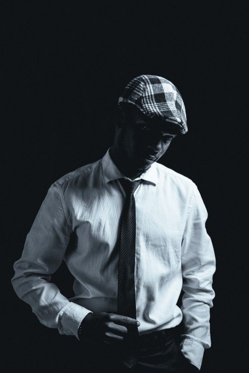 Free Elegant black and white portrait of a fashionable man in studio lighting. Stock Photo