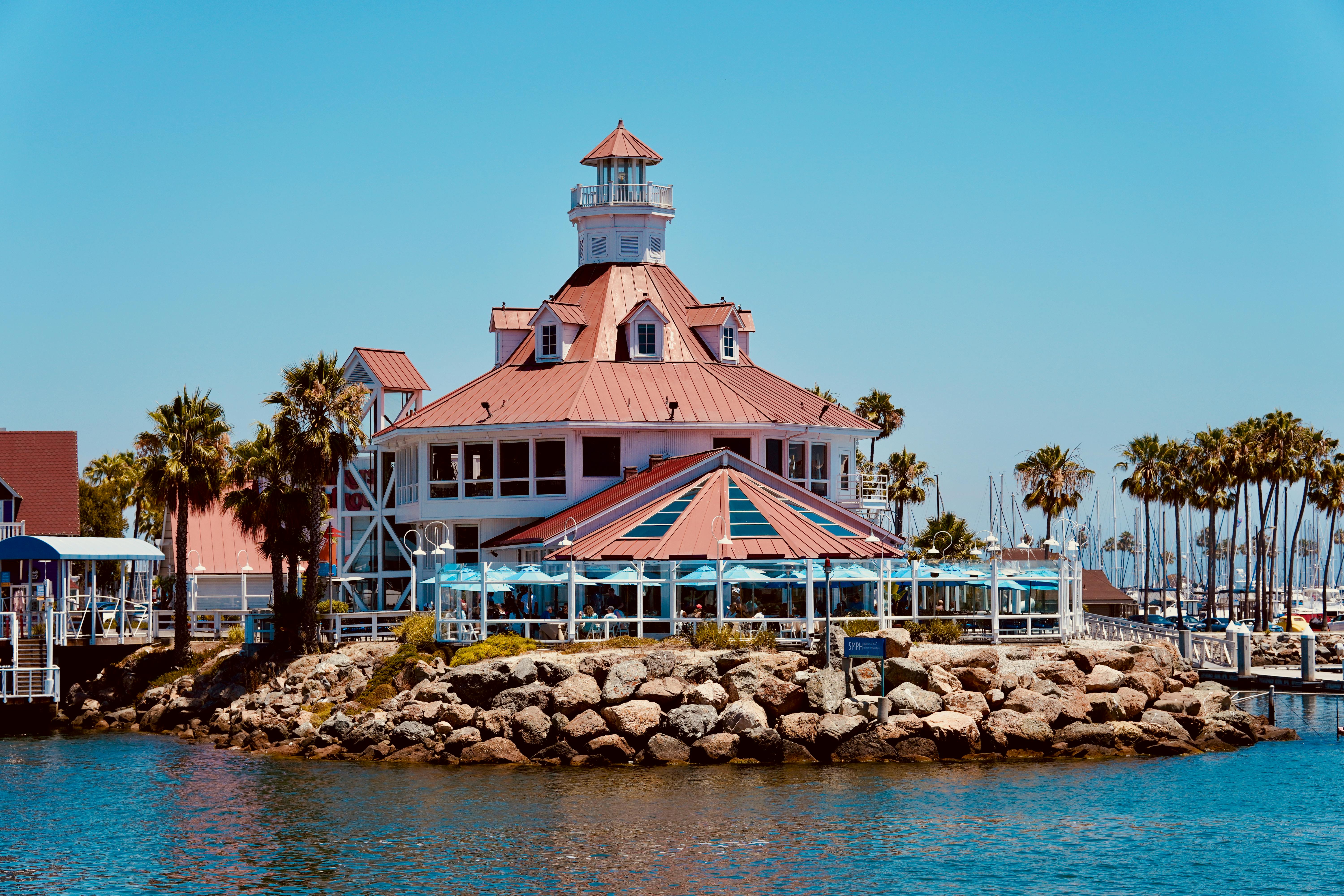 Beautiful lighthouse at Long Beach Marina, surrounded by palm trees and ocean views.