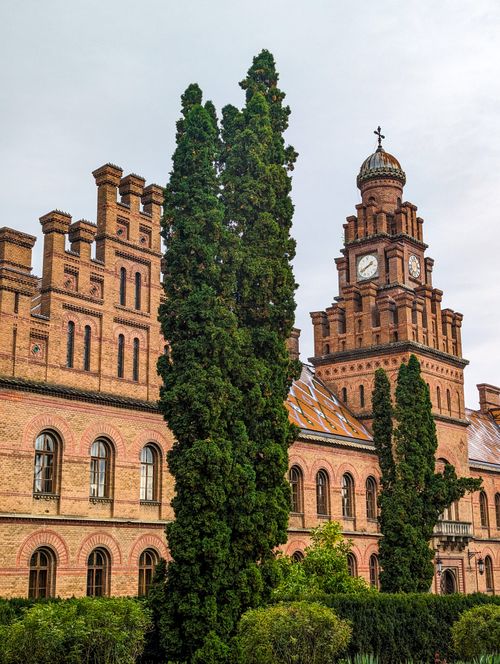 Free Stunning architectural view of Chernivtsi University's facade, capturing its historical charm and lush greenery. Stock Photo