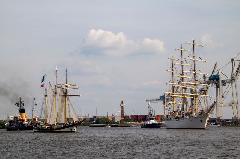 Tall ships with towering masts and rigging moored in a harbour before the Armada festival