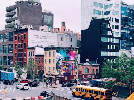 Colorful cityscape of New York with urban murals, modern architecture, and bustling street life.