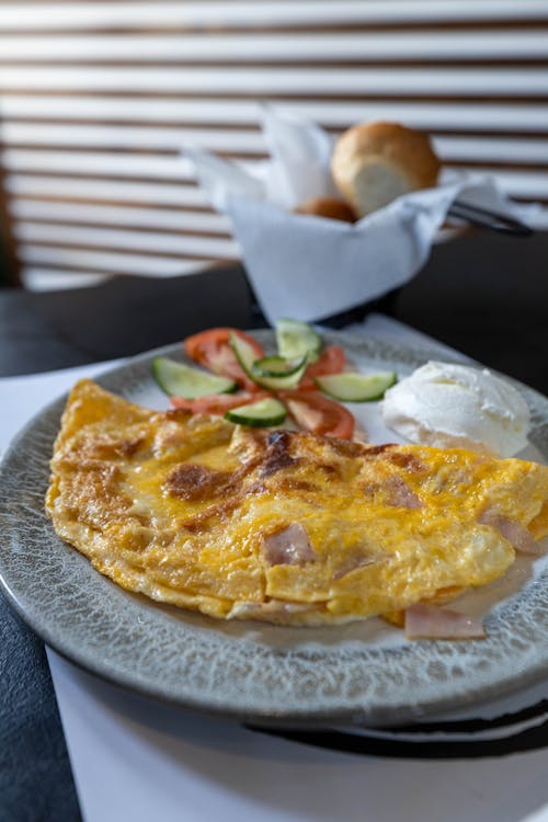 An omelet with ham and cheese on a plate