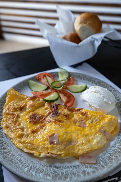 An omelet with ham and vegetables on a plate