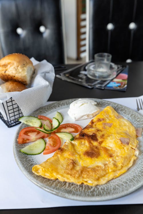 A plate with an omelet and bread on it