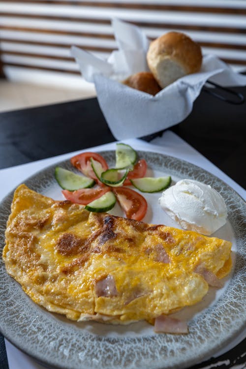 A plate with an omelet and bread on it