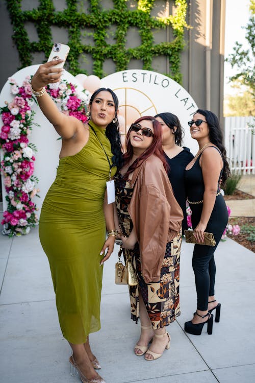 A woman taking a selfie with a group of women