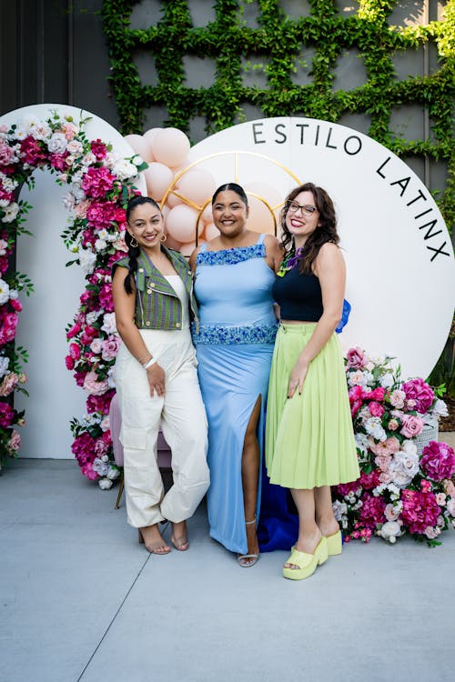 Three women pose for a photo at an event