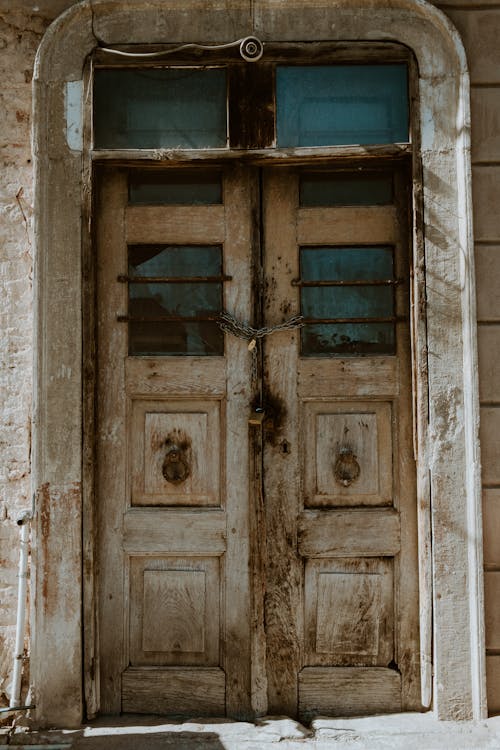 An old wooden door with a broken window